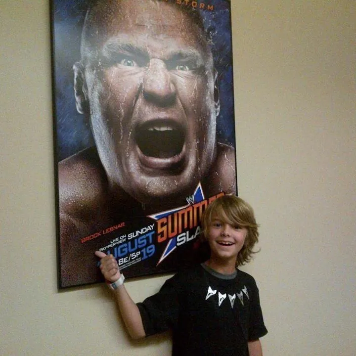 Young Brock beside a Brock Lesnar poster